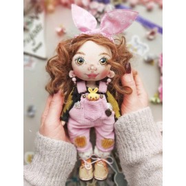 Dovana mergaitei lėlė, pagaminta iš audinio rausvu kombinezonu ir geltonu triušiu.